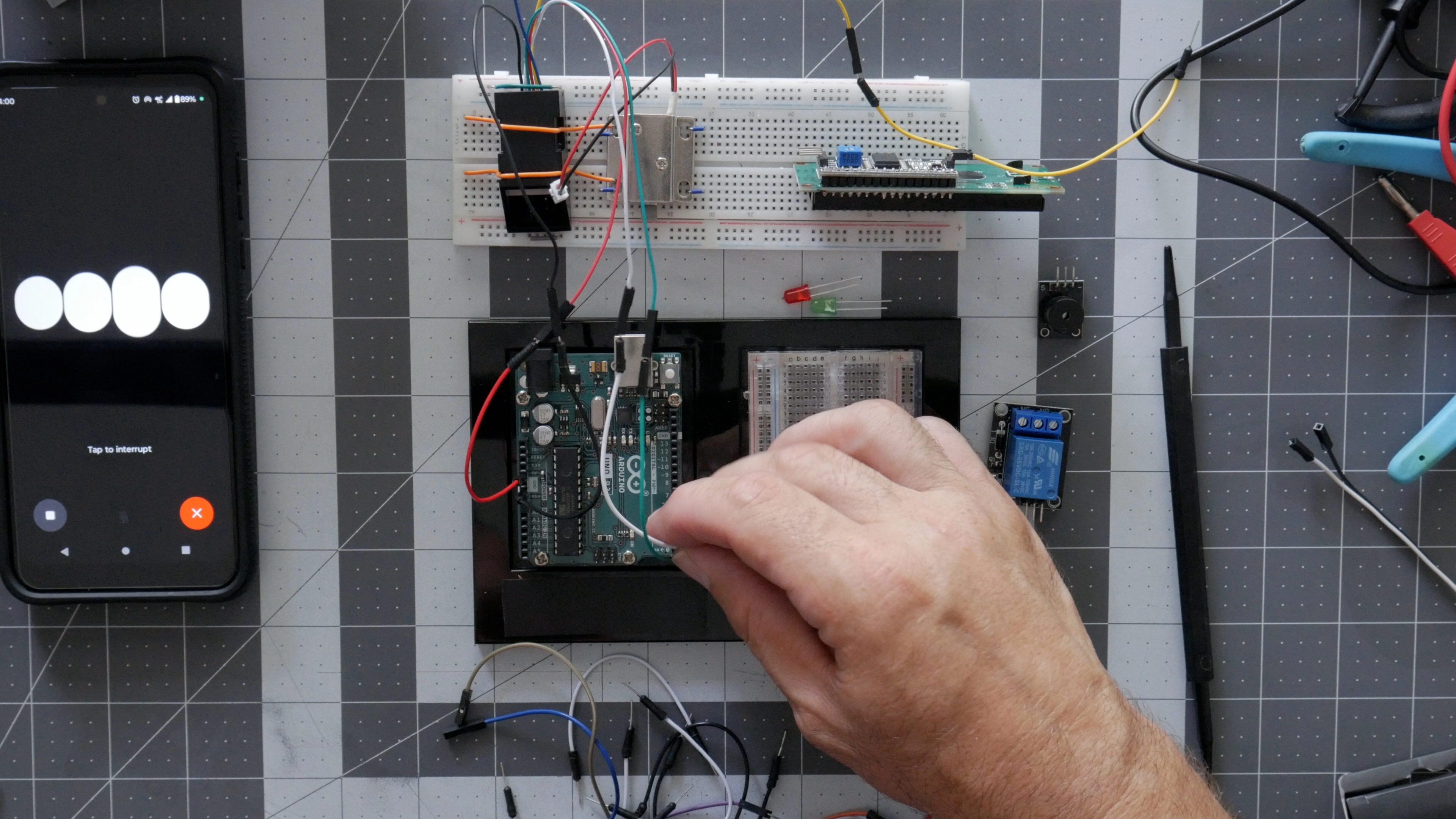 Top-down workbench view of GPT-4 and Arduino prototyping session